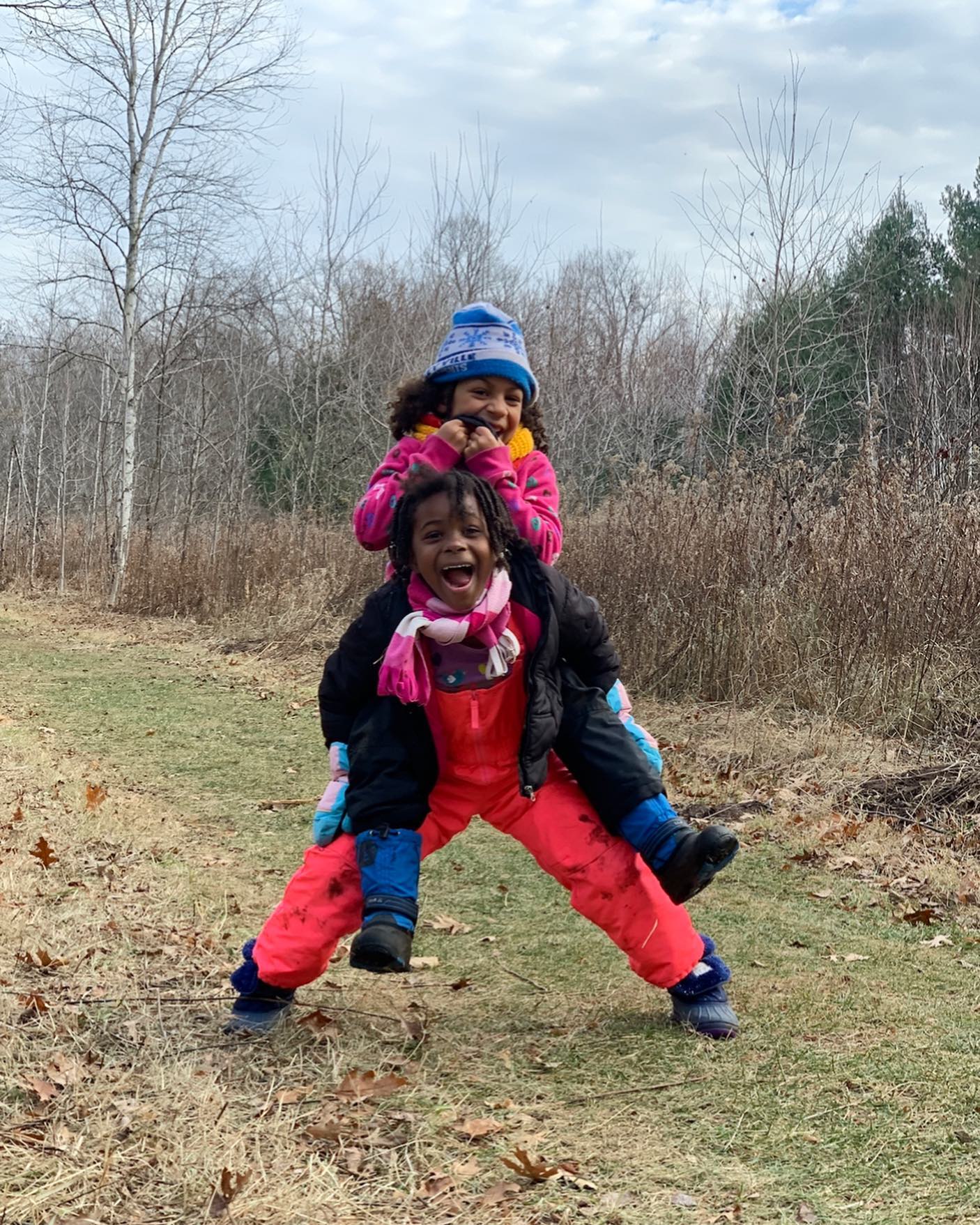 two children dressed for winter having fun